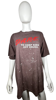 Experience nostalgia and make a statement with this vintage D.A.R.E T-shirt featuring a stunning paint splatter effect on the front.