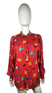 Get ready to unleash your playful side with this quirky Vintage Chaus Button Up! Made from %100 Spun Rayon, this button up features a unique geometric all over print in a bold red color. Perfectly sized at large, the chest measures 34", sleeve 22", and...