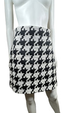 Load image into Gallery viewer, Indulge in the classic and timeless style of the Black and White Houndstooth Skirt. This skirt features a striking houndstooth print, zipper closure, and measured flat waist of 28 inches. With a hip measurement of 37 inches and a flattering length of 18 1/2 inches, this skirt is sure to make a statement.