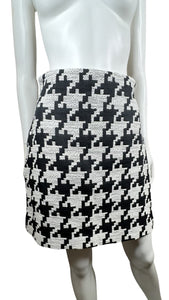 Indulge in the classic and timeless style of the Black and White Houndstooth Skirt. This skirt features a striking houndstooth print, zipper closure, and measured flat waist of 28 inches. With a hip measurement of 37 inches and a flattering length of 18 1/2 inches, this skirt is sure to make a statement.