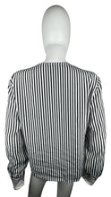 Load image into Gallery viewer, This Vintage Notations blouse features classic black and white pin stripes, perfect for adding a touch of retro charm to any outfit. Though it may be missing one button, the chest measures at a flattering 32 inches and the sleeves at a stylish 22 inche...
