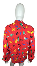 Load image into Gallery viewer, Get ready to unleash your playful side with this quirky Vintage Chaus Button Up! Made from %100 Spun Rayon, this button up features a unique geometric all over print in a bold red color. Perfectly sized at large, the chest measures 34&quot;, sleeve 22&quot;, and...