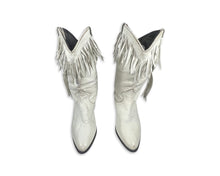 Load image into Gallery viewer, These ACME cowgirl boots from the 80&#39;s are a unique find, with their white color and fringes. While the size is unknown, the boot length measures 10 inches, which typically translates to a size 8 or 9. Since they&#39;re vintage, they may run a bit smaller...