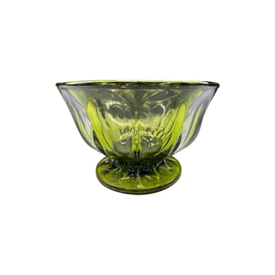 A vintage mid-century green glass pedestal footed bowl measuring at 4 inches tall and 6 inches in diameter.