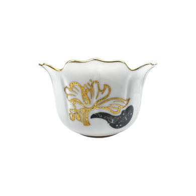 A single antique white porcelain tea cup with gold trim decorative design. The cup measures at 2 1/2 inches tall and 4 1/2 inches in diameter.