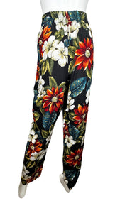 The Vintage Léger Floral Pant features a bold floral print, making a statement with its 100% Rayon fabric. With a high waisted fit, it measures 26" around the waist and has a comfortable 28" inseam. Its chic harem style and length of 41" make it a unique addition to any wardrobe.