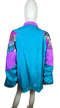 Load image into Gallery viewer, This Vintage Just For Women Windbreaker Jacket is perfect for those who like to mix things up. In bold Teal and purple, this 90&#39;s jacket has an oversized fit that measures 46&quot; at the chest, with 25&quot; sleeves and a length of 29&quot;.