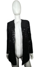 Load image into Gallery viewer, Experience the dazzling beauty of our Vintage ILGWU Sequin Blazer, crafted by the renowned International Ladies Garment Workers Union. This stunning black blazer features measurements of 34&quot; chest, 23&quot; sleeves, and 27&quot; length in size 11, and 33&quot; chest,...