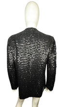 Load image into Gallery viewer, Experience the dazzling beauty of our Vintage ILGWU Sequin Blazer, crafted by the renowned International Ladies Garment Workers Union. This stunning black blazer features measurements of 34&quot; chest, 23&quot; sleeves, and 27&quot; length in size 11, and 33&quot; chest,...