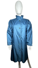 Load image into Gallery viewer, This Vintage Objectives jacket in blue nylon offers a unique trench style with a double layered design and removable inner layer. With measurements of 36&quot; in the chest, 22 1/2&quot; in the sleeves, and a length of 45&quot;, it&#39;s a practical and stylish addition...