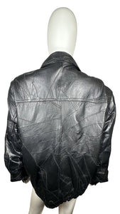 Vintage 80's Genuine Black Leather Jacket that zips and buttons that is in excellent condition. Measured Flat Chest - 42" Sleeve - 24" Length - 31"