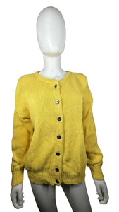 Indulge in the timeless charm of this bright yellow cardigan sweater, with its stylish knitted design, classic button-up closure, and flattering measurements of 42" chest, 19" sleeves, and 24 1/2" length. You'll love the way it looks and feels, allowin...