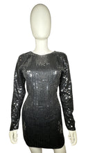 Load image into Gallery viewer, Experience the irresistible glamour of the Vintage Maison Magique Sequin Dress. This stunning black cocktail dress features long sleeves and a mini length, all adorned with sparkling sequins. With a flat chest measurement of 31 inches, sleeve length of...