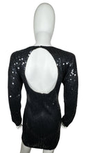 Load image into Gallery viewer, Experience the irresistible glamour of the Vintage Maison Magique Sequin Dress. This stunning black cocktail dress features long sleeves and a mini length, all adorned with sparkling sequins. With a flat chest measurement of 31 inches, sleeve length of...