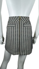 Load image into Gallery viewer, This Express skirt comes in a size 2 and features a fun black and white pattern with a bold gold zipper in the front. When laid flat, it measures 26&quot; at the waist, 36&quot; at the hips, and has a length of 24&quot;.