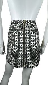 This Express skirt comes in a size 2 and features a fun black and white pattern with a bold gold zipper in the front. When laid flat, it measures 26" at the waist, 36" at the hips, and has a length of 24".