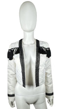 Load image into Gallery viewer, Get ready to make a statement in this White and Black crop tassel jacket! With a flat chest measuring at 36 inches, sleeves at 24 and a half inches, and a length of 19 inches, this jacket is both stylish and comfortable. Perfect for adding a fun and pl...