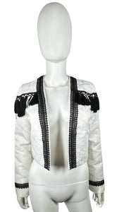 Get ready to make a statement in this White and Black crop tassel jacket! With a flat chest measuring at 36 inches, sleeves at 24 and a half inches, and a length of 19 inches, this jacket is both stylish and comfortable. Perfect for adding a fun and pl...