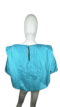Load image into Gallery viewer, Get ready to add some retro flair to your wardrobe with this Vintage Novelle 80s Teal Blouse! Featuring a stretch waist band and shoulder pads, this blouse will give you a bold and unique look. When laid flat, it measures 42&quot; at the chest and has a len...