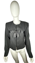 Load image into Gallery viewer, Introducing the Vintage Leslie Fay Black Crop Blazer - the perfect combination of chic and playful! This blazer features a front button closure, satin bow detail, and shoulder pads, along with measurements of 35&quot; chest, 22&quot; sleeves, and 21&quot; length when...
