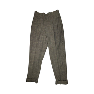 A unique throwback Liz Claiborne collection featuring a luxurious wool tweed suit adorned with houndstooth pattern. This suit comes with a blazer and pants set, with measurements of blazer chest at 30 inches, sleeve at 23 inches, and length at 29.5 inc...