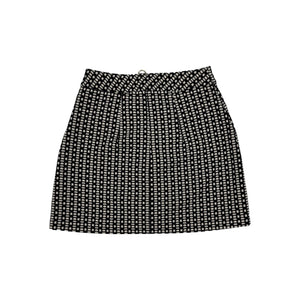 This Express skirt comes in a size 2 and features a fun black and white pattern with a bold gold zipper in the front. When laid flat, it measures 26" at the waist, 36" at the hips, and has a length of 24".