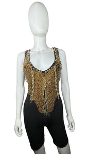 This Vintage Black and Gold Beaded Leotard has a stretchy and comfortable feel. Although it may show some wear and tear, it still holds its unique charm with a few holes and a missing bead on the chest. In the past, I had a skirt attached to the back t...