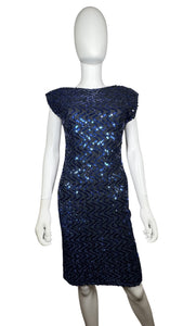 This Vintage Blue Sequin Dress is truly stunning with its captivating sequins, chic pencil silhouette, and alluring scoop back. Zipping up on the side, it fits seamlessly on the body, measuring at 29" for the chest, 26" for the waist, and 28" for the h...