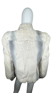 Experience the luxurious warmth and style of this stunning Vintage Dyed Rabbit Fur Coat from the 80's. With its unique white and grey color combination and elegant button detailing, this coat is sure to make a statement. Measured flat, the chest measur...