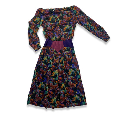 Vintage Patty O'neil by Monique Robidoux Floral Dress is a purple long sleeve dress with an all over floral print and built in suede belt. Measured Flat Chest - 38