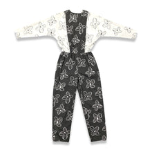 Load image into Gallery viewer, Introducing a one-of-a-kind black and white floral jumpsuit from the 80&#39;s, complete with a stretch waist for ultimate comfort. Measurements include: Chest - 39&quot;, Sleeve - 24&quot;, Waist - 26&quot;, Hips - 40&quot;, Inseam - 28&quot;, Length - 60&quot;. Don&#39;t miss this rare vi...