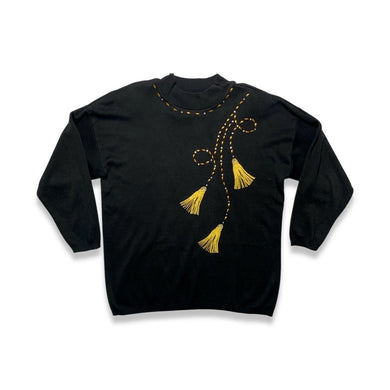 Vintage AfterShock Sweatshirt is a black long sleeve sweatshirt with gold embellishment, embroidered tassels and shoulder pads.  Measured Flat     Chest - 46