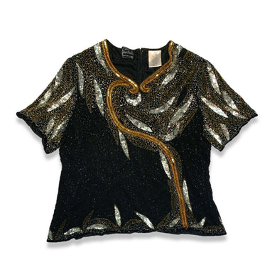 Get ready to shine with this Vintage Jennifer Joseph Lebon top that doubles as an oversized dress! The sequins and beads add a touch of glam, and it measures at a comfortable chest size of 46 inches with 11 1/2 inch sleeves and a 29 inch length.