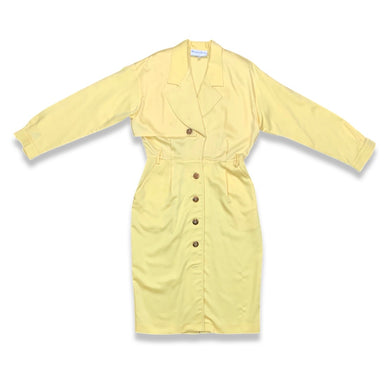 This vintage yellow trench dress can do double duty as both a dress and an open trench coat. One of the buttons is currently M.I.A. at the very bottom, but it's still a standout piece. When lying flat, it measures 22 inches for the sleeve, 32 inches fo...