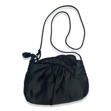 This is a Vintage small black satin feel beaded purse that can be worn as a crossover bag or you can tuck the strap in and use it as a clutch. 