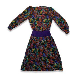 Vintage Patty O'neil by Monique Robidoux Floral Dress is a purple long sleeve dress with an all over floral print and built in suede belt. Measured Flat Chest - 38" Sleeve - 25" Waist - 26" Hips - 34" Length - 49"