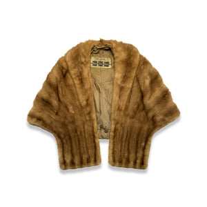 This brown fur stole is a vintage product from the prestigious Fur Salon at Carson, Pirie, Scott & Co. It showcases expert craftsmanship and timeless design, making it a valuable addition to any wardrobe.